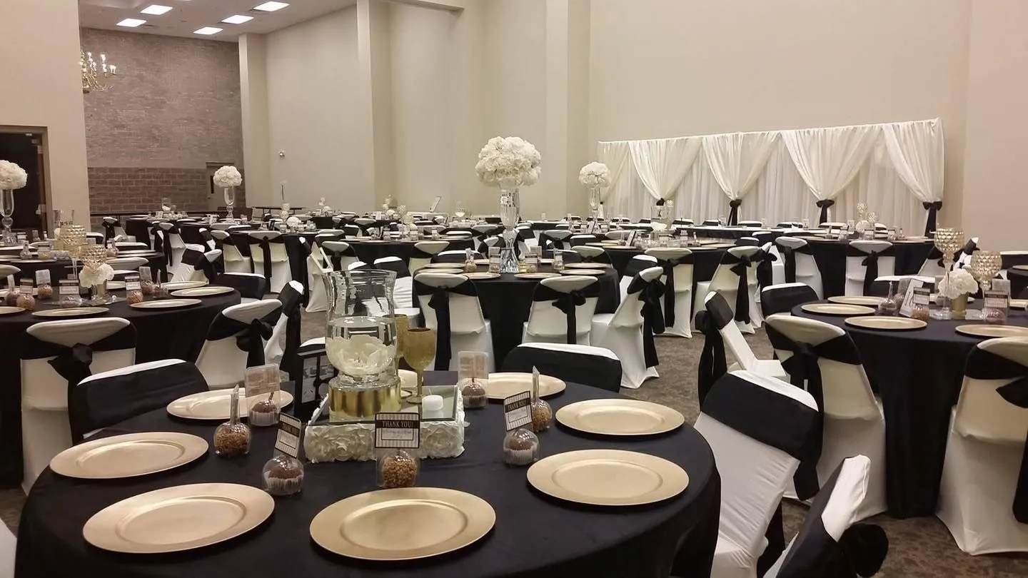 Champion Hall set for a formal event with black-and-gold banquet tables